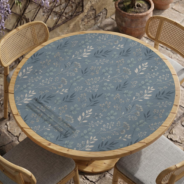 Blue mahjong mat with a botanical floral pattern, pale leaves, and delicate stems on a dusty blue background.