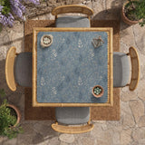 Blue mahjong mat with a botanical floral pattern, pale leaves, and delicate stems on a dusty blue background.