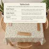 Cream square mahjong mat with a sage vine and leaf botanical pattern and scalloped edges.
