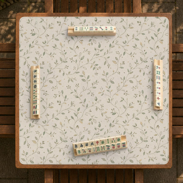 Sage green mahjong mat with vine and botanical artwork in cream neutral tones, shown in a cottagecore style with a tablecloth-style format.