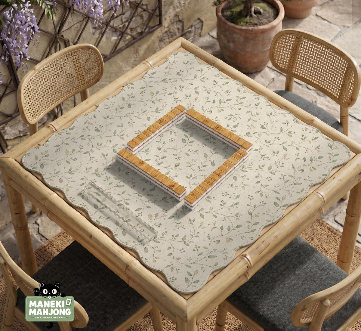 Sage green botanical mahjong mat with a cream background, trailing vines, and muted leaf designs.