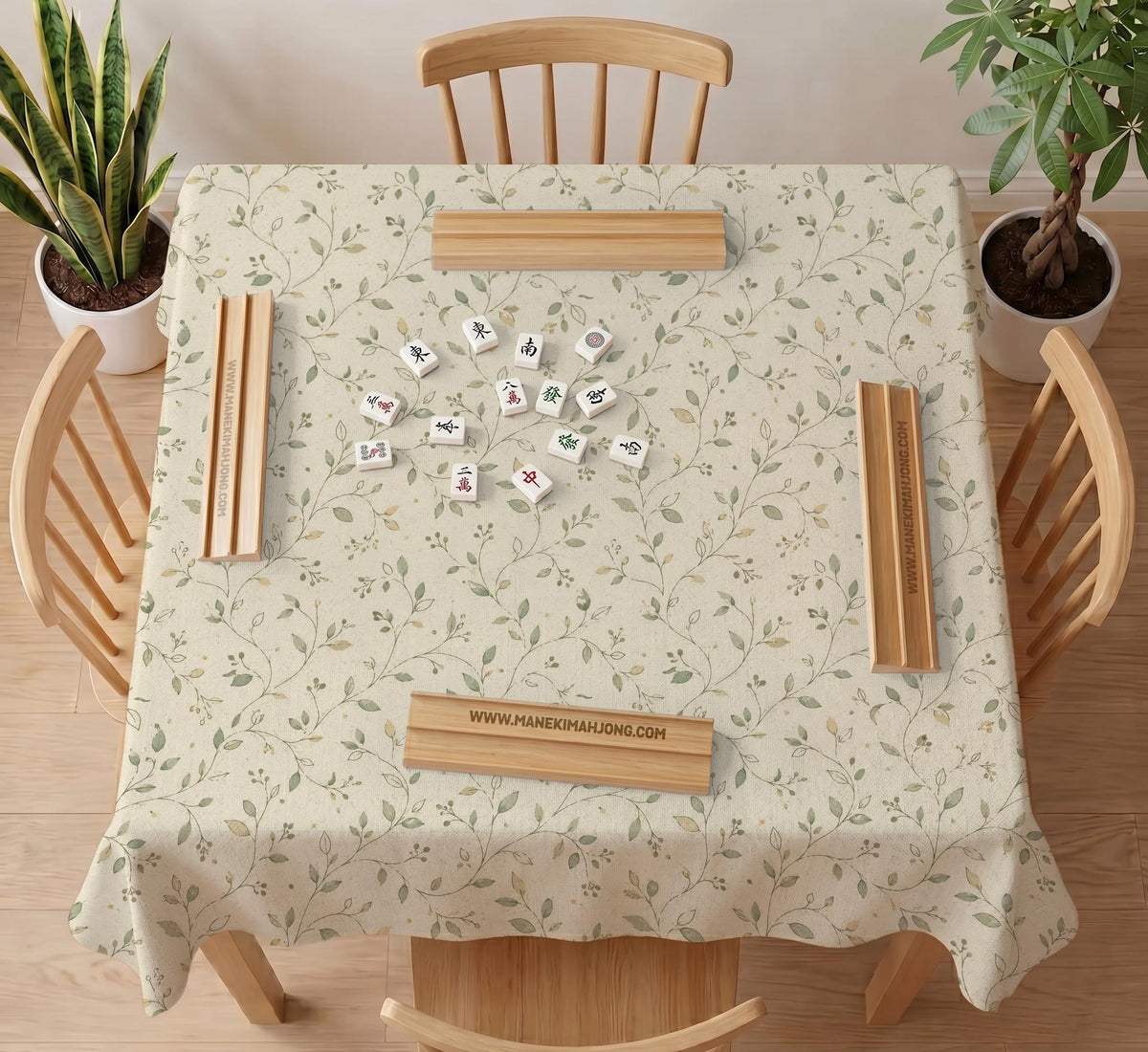 Sage green botanical mahjong mat with a cream background, trailing vines, and muted leaf designs.