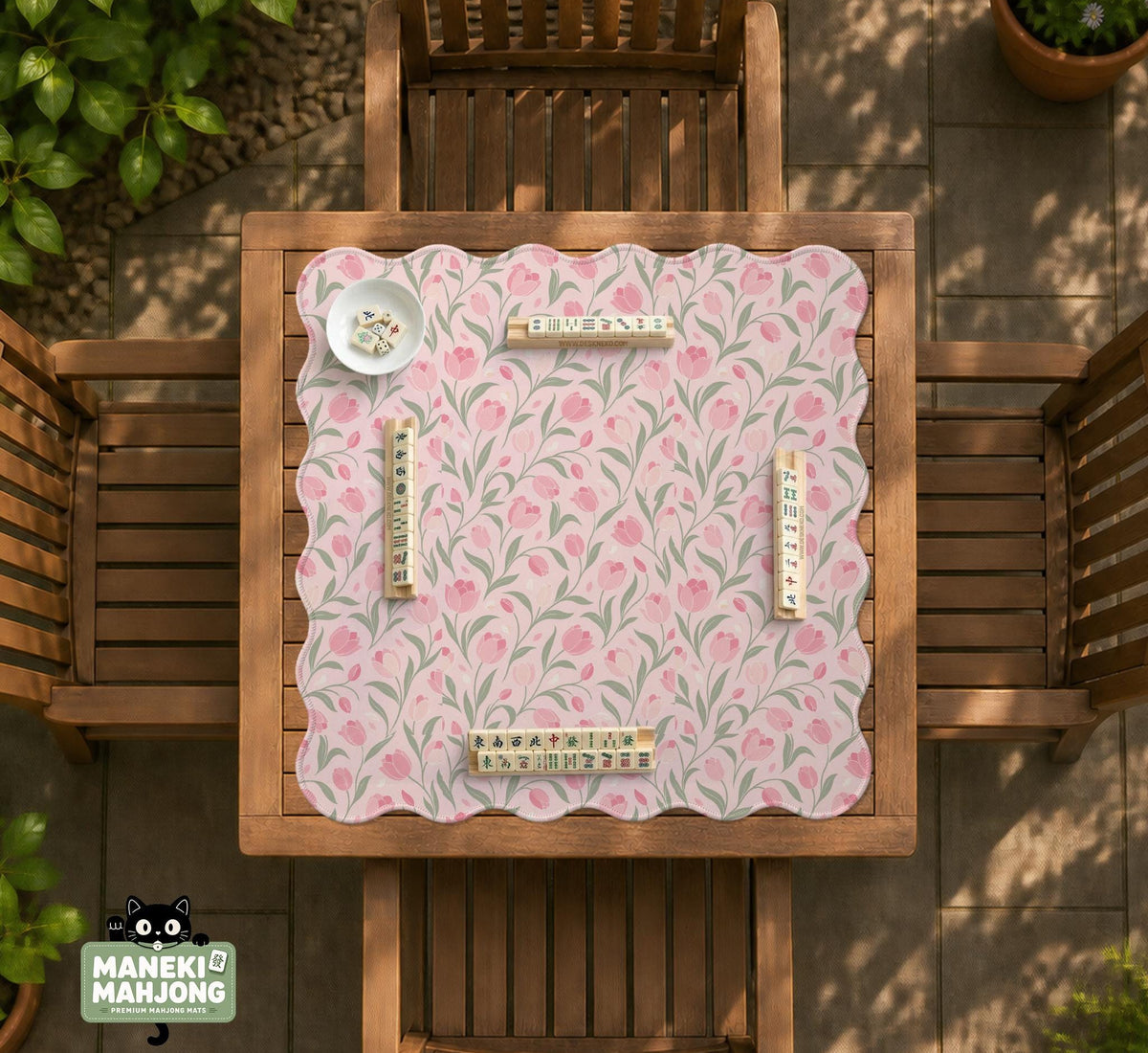 A pink mahjong mat with tulip flowers, sage leaves, and a light pastel background.