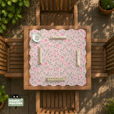 A pink mahjong mat with tulip flowers, sage leaves, and a light pastel background.