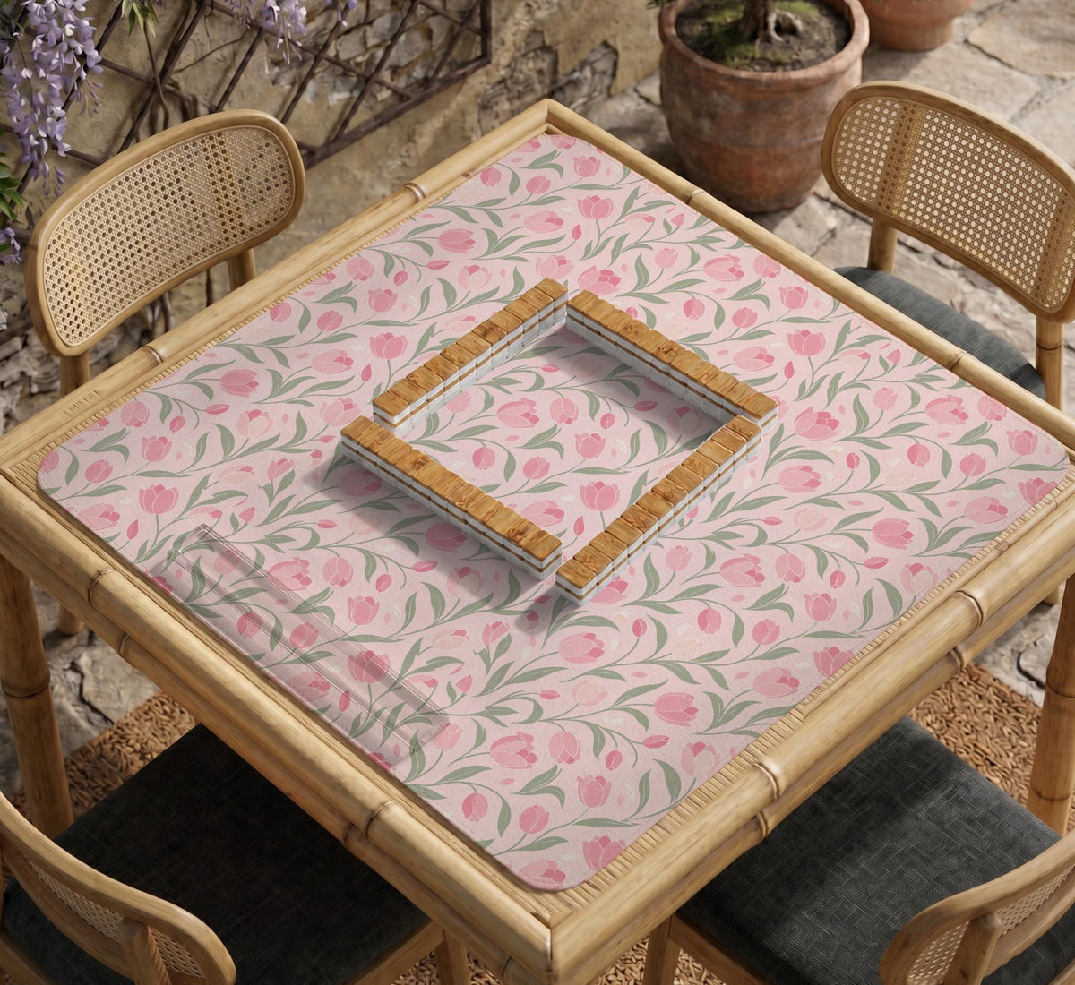 A pink mahjong mat with tulip flowers, sage leaves, and a light pastel background.