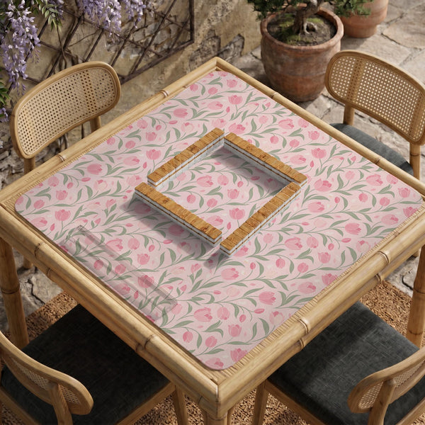 A pink mahjong mat with tulip flowers, sage leaves, and a light pastel background.
