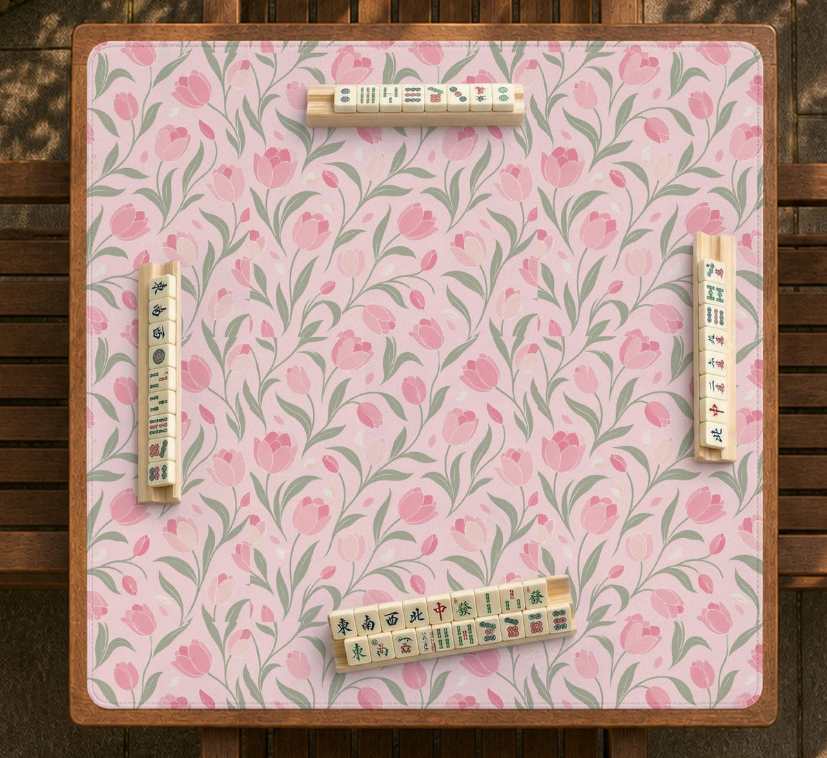 Pink mahjong mat with a tulip floral pattern in blush and sage tones and a scalloped edge.