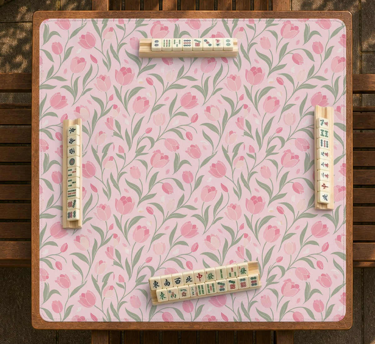 A pink mahjong mat with tulip flowers, sage leaves, and a light pastel background.