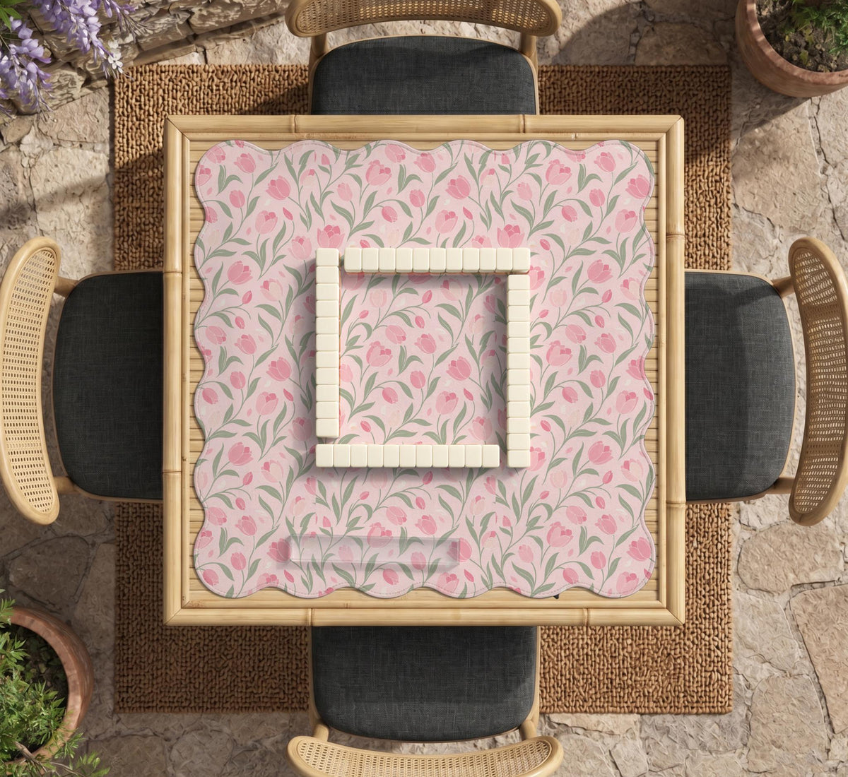 Pink mahjong mat with a tulip floral pattern in blush and sage tones and a scalloped edge.