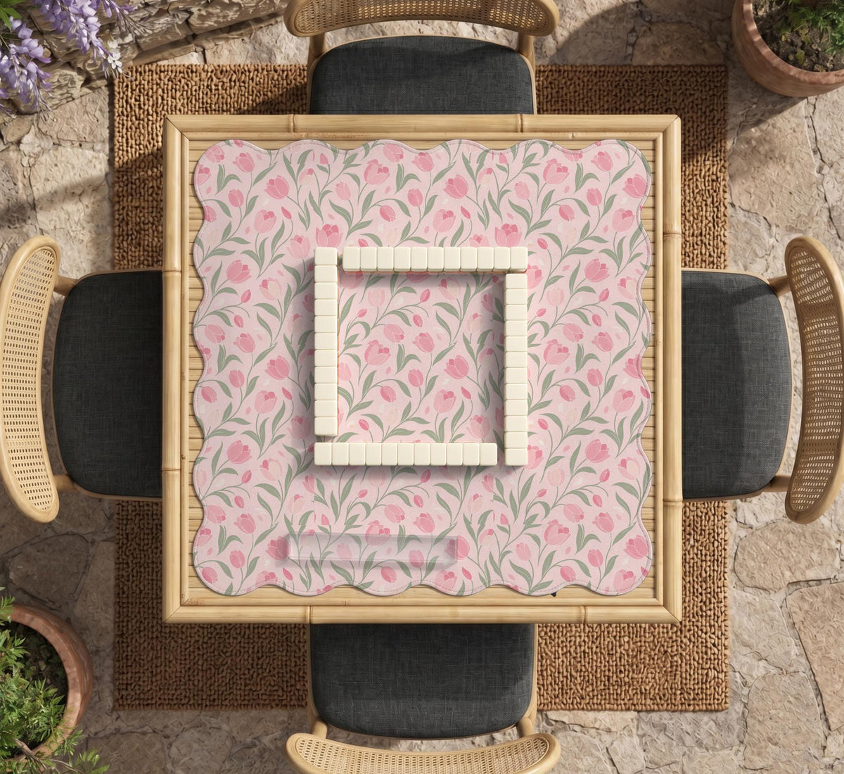 A pink mahjong mat with tulip flowers, sage leaves, and a light pastel background.