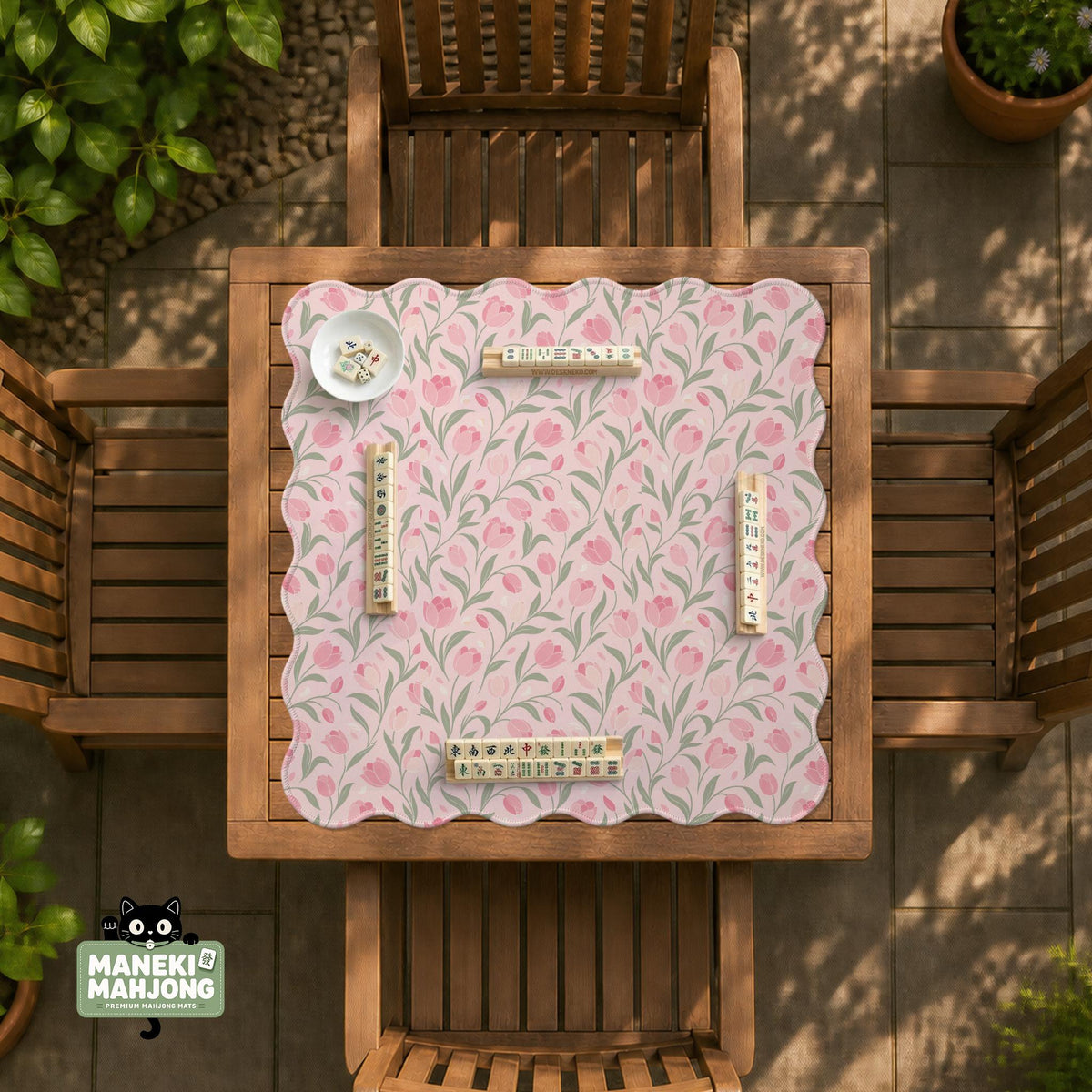 Pink mahjong mat with a tulip floral pattern in blush and sage tones and a scalloped edge.