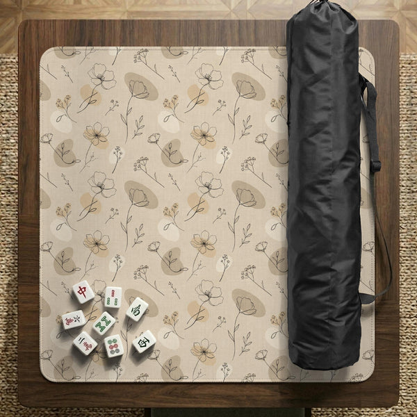 Neutral floral mahjong mat with delicate botanical line art and a scalloped edge on a cream background.