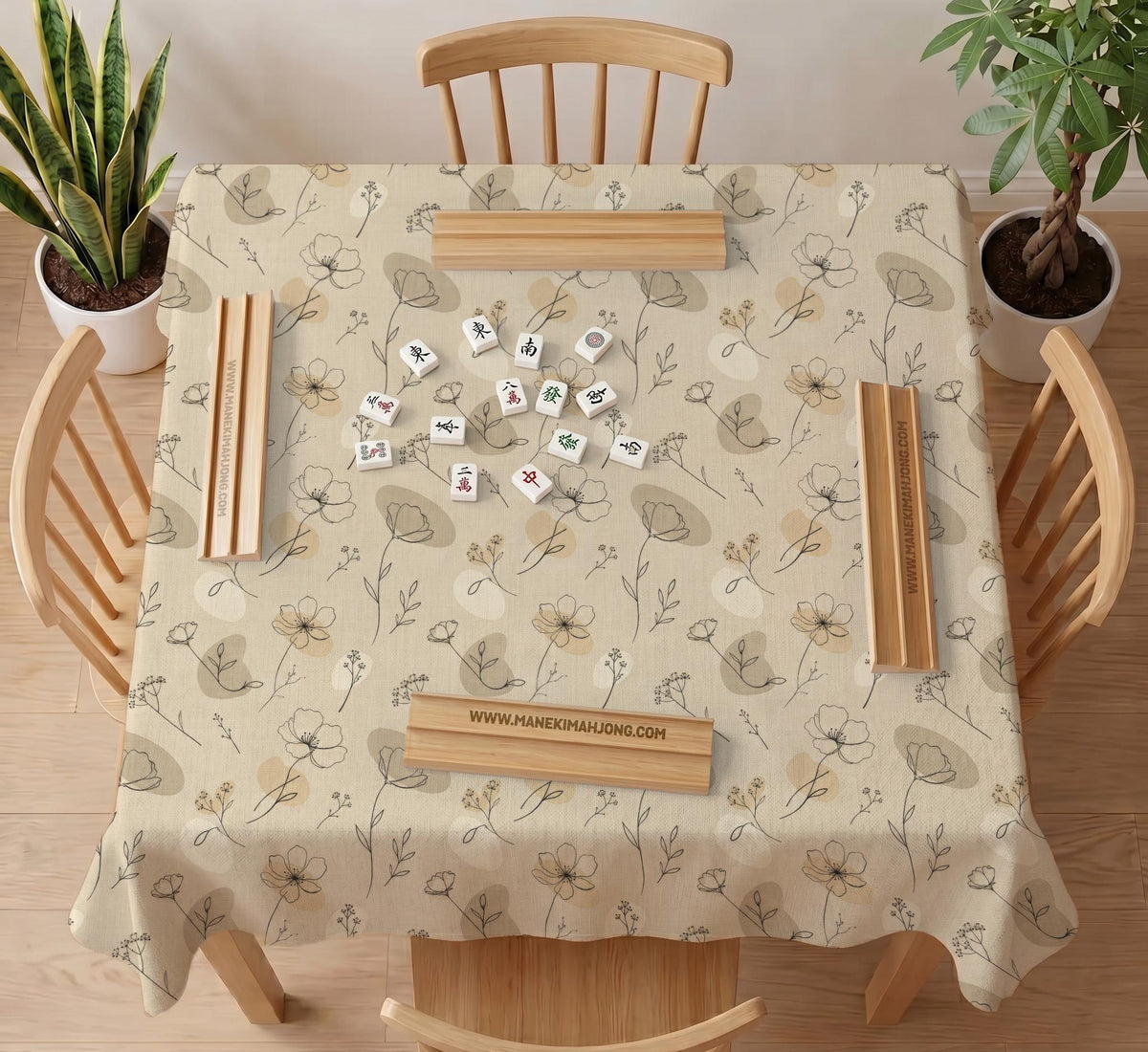 Neutral floral mahjong mat with delicate botanical line art and a scalloped edge on a cream background.