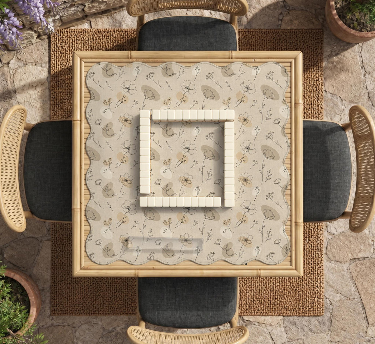 Neutral floral mahjong mat with delicate botanical line art and a scalloped edge on a cream background.
