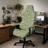 Green chair cover with a sage floral botanical print shown on a high-back gaming chair and office chair.