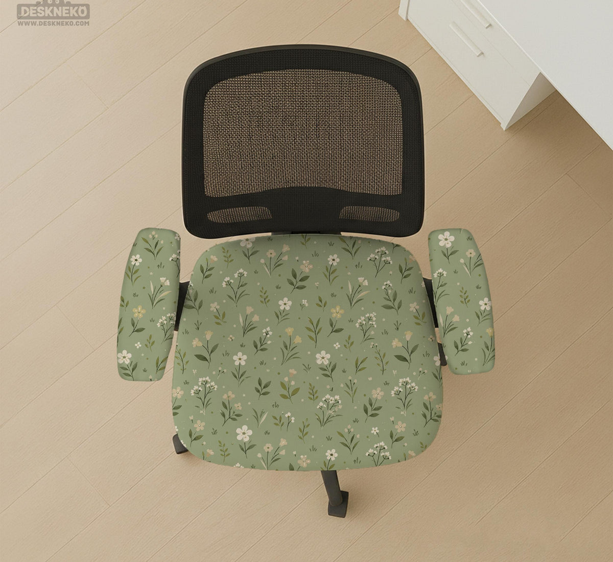 Sage green chair cover with a small floral print shown on a desk chair with a high back.
