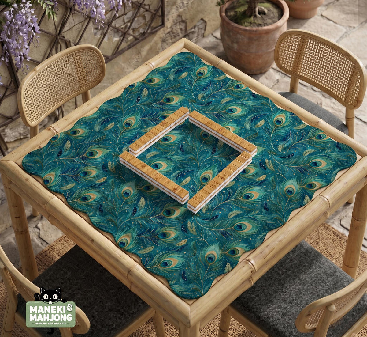 A teal mahjong mat with a peacock feather pattern and scalloped edges.