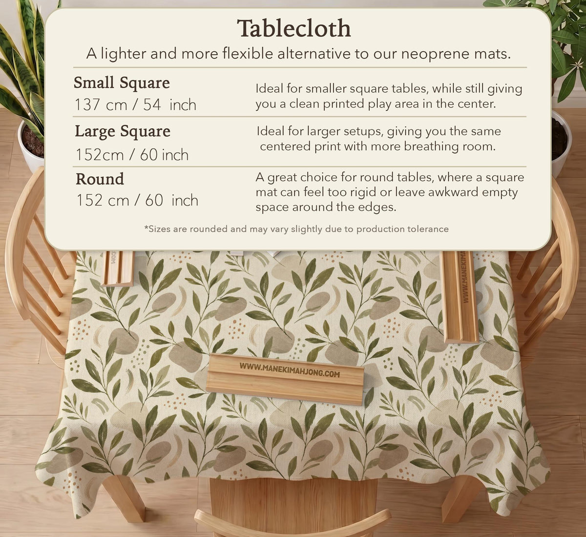 Green botanical mahjong mat with sage leaf and floral design and a scalloped edge.