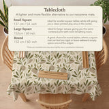 Green botanical mahjong mat with sage leaf and floral design and a scalloped edge.