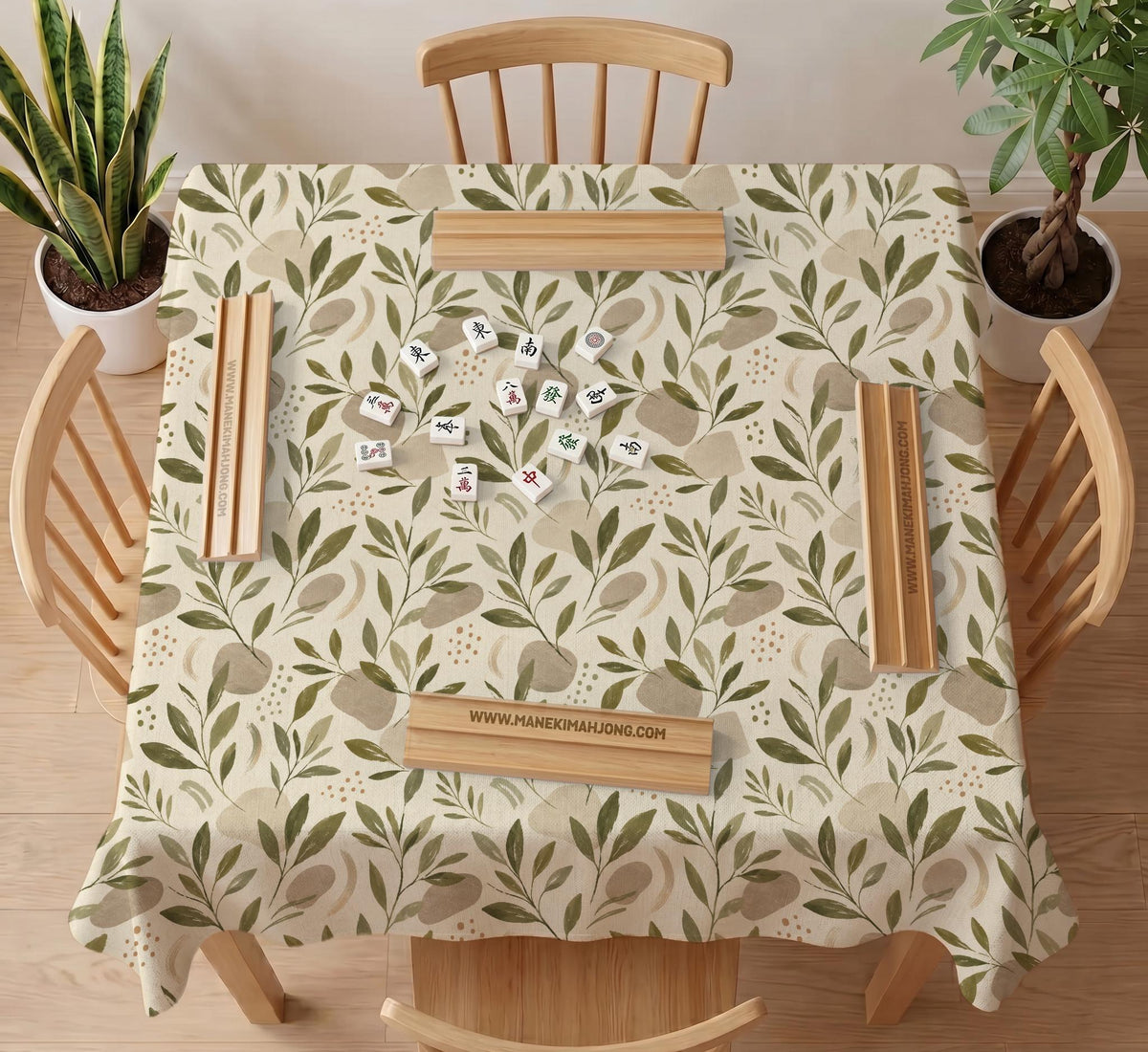 Green botanical mahjong mat with sage leaf and floral design and a scalloped edge.
