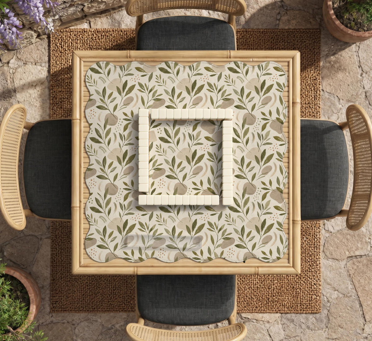 Green botanical mahjong mat with sage leaf and floral design and a scalloped edge.